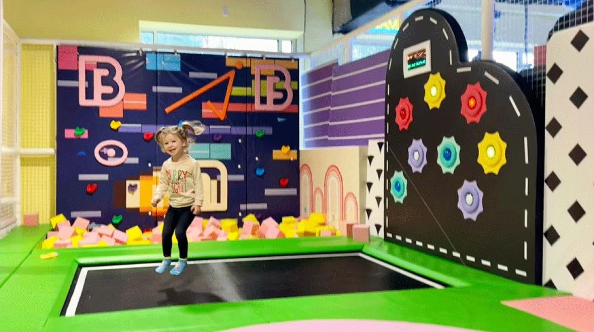 little kid jumping on trampoline during an indoor birthday party near Seattle