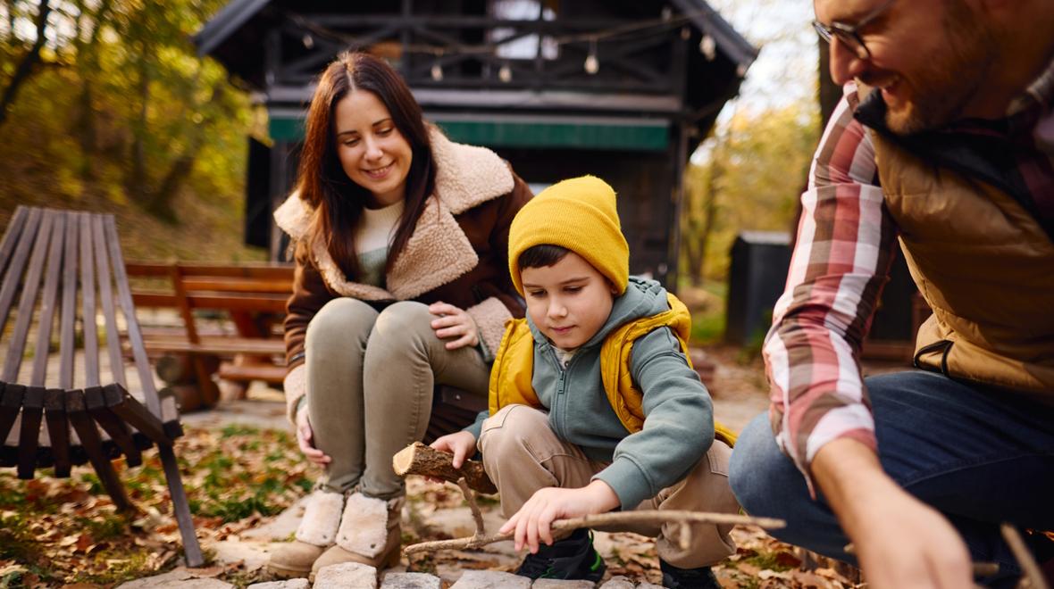 family at a rustic cabin