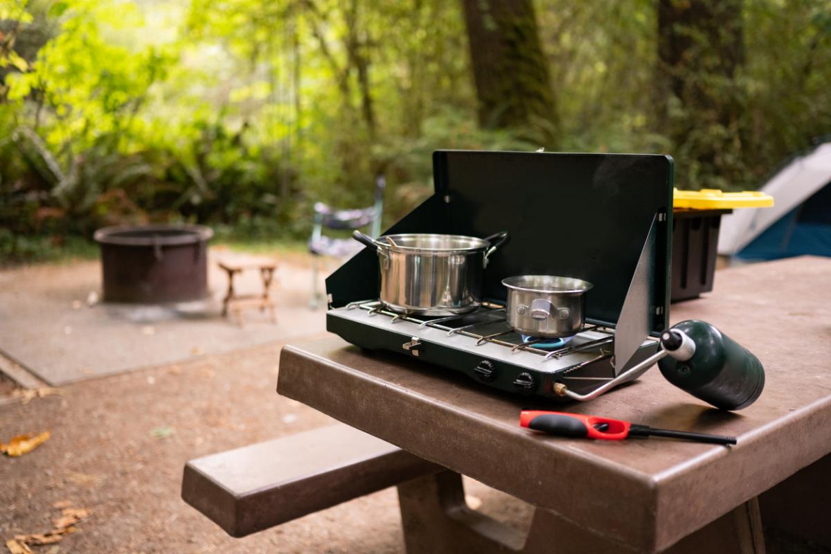 https://www.parentmap.com/sites/default/files/styles/1200x1200_scaled/public/2022-05/Camping%20colman%20camp%20stove%20istock_0.jpg?itok=i08cngln