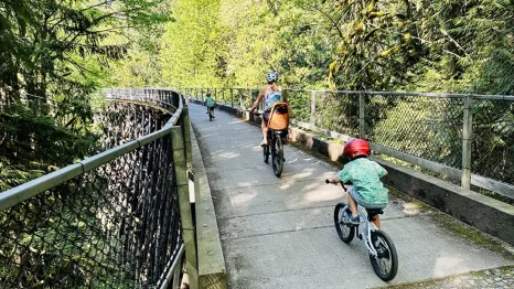 Families ride bikes over the Tokul Creek Trestle in Snoqualmie
