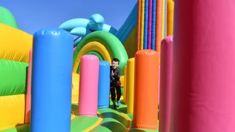 Young boy climbs through colorful inflatables at Bounce The City Seattle