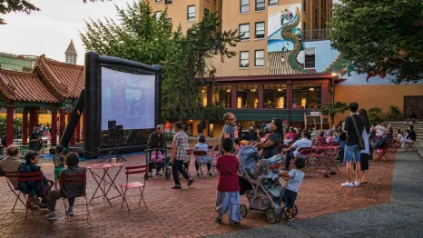 Families enjoying an outdoor movie in Seattle this summer at a local park