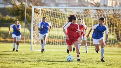 Young women playing soccer in the spring and are injury-free