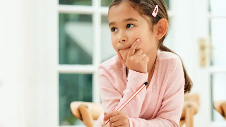 a thoughtful child looks to the side as she builds memory skills