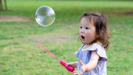 A toddler girl playing outside in the park enjoying free things to do in Seattle