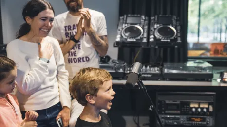 A young music fan takes the mic for Kids Day on the Morning Show at KEXP. Photo: Melissa DeAun for KEXP