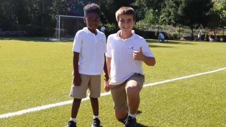 Two boys on a field at St. Thomas school