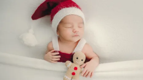 sleeping baby wearing a santa hat for a sweet and easy holiday photo