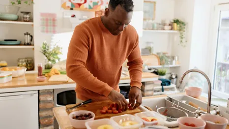 dad in a kitchen prepping lunches for the week