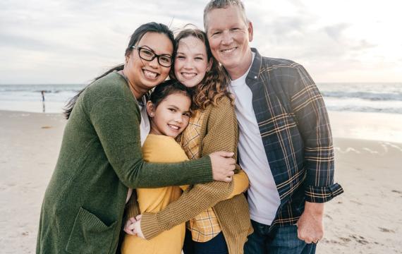 Family smiling on the beach