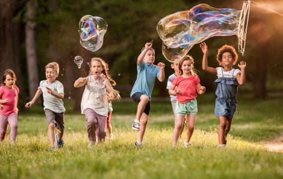Kids playing outside with bubbles enjoying free family fun near Seattle