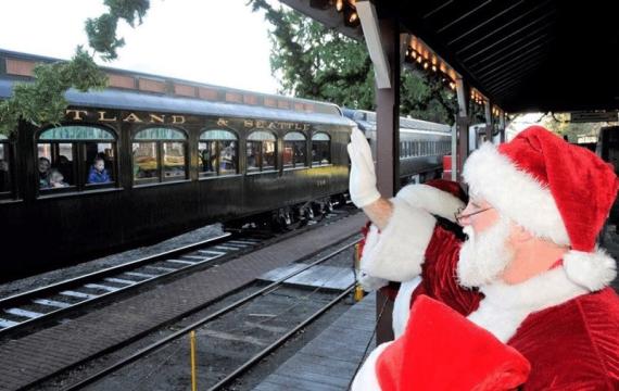 During a Santa train ride, Santa waves as the Northwest Railway's Santa Limited Train rolls into the station