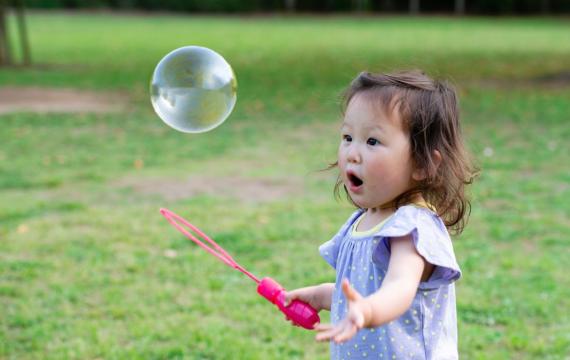 A toddler girl playing outside in the park enjoying free things to do in Seattle