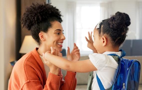 mom and child say goodbye as the child goes back to school