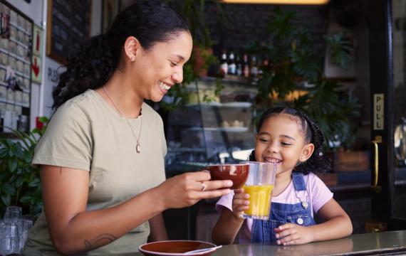 Mom and daughter in a coffee shop having special drinks together