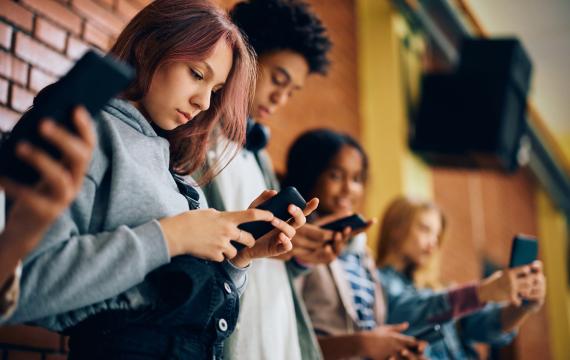 teen students using phones at school