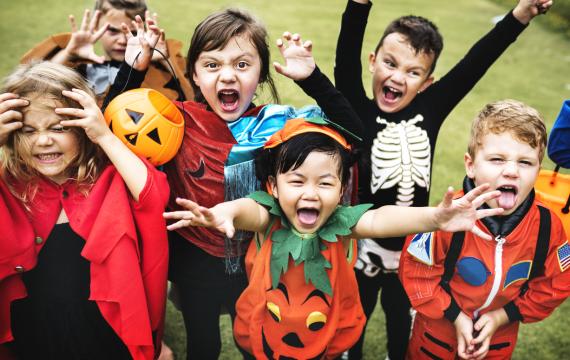 children trick or treating in Halloween costumes