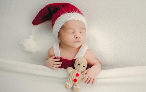 sleeping baby wearing a santa hat for a sweet and easy holiday photo