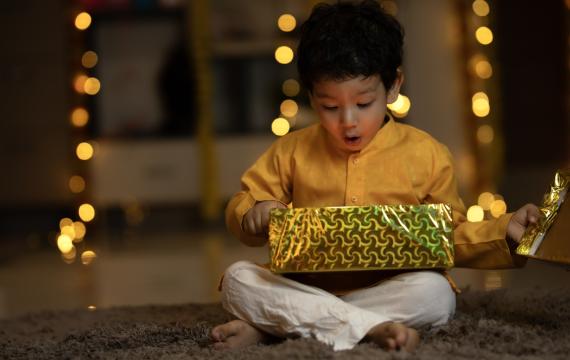 Child opening the perfect holiday gift