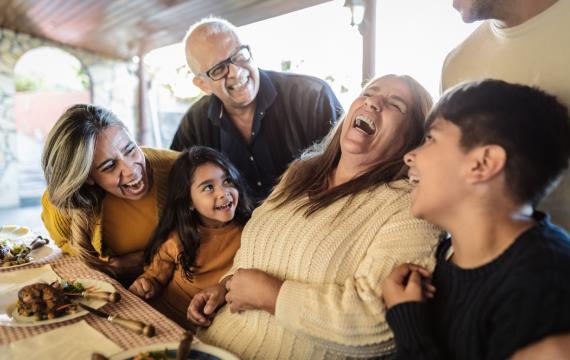 A family laughing and enjoying time together on Thanksgiving 