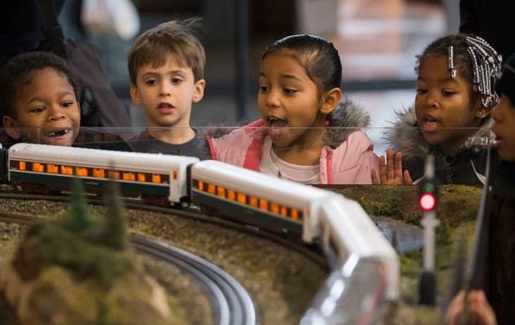 kids watching a model train at the Washington State History Museum, one of the many things for families to do this weekend near Seattle