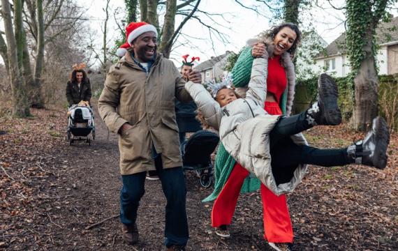 family outside enjoying Christmas Day on their way to a nearby activity