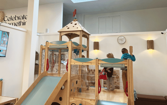 Young kids playing in the indoor play space at Holiday Cafe in Puyallup, a kid-friendly coffee shop