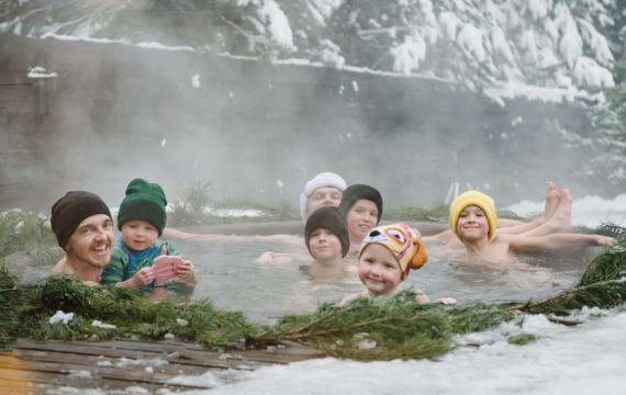 Adults and kids in a natural hot spring