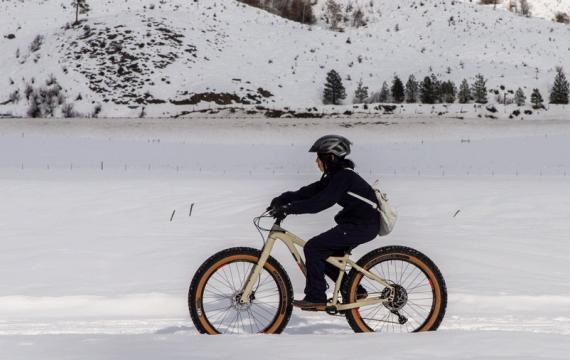 Kid riding a fat bike in the snow outside of Seattle in Methow Valley, a fun winter sport activity for families