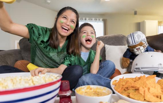 mom and son having fun watching the Super Bowl