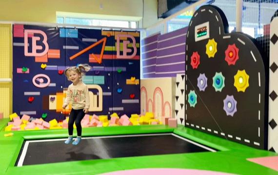 little kid jumping on trampoline during an indoor birthday party near Seattle