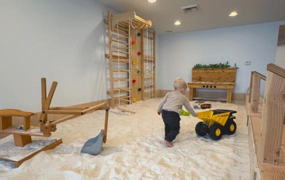 young boy pushing a truck in the lavender-infused sand pit at Wildflower Play Studio in Enumclaw