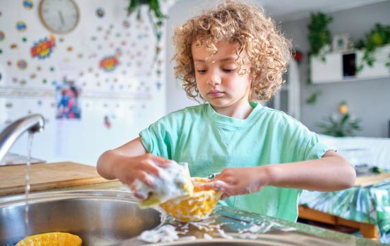 child washing dishes