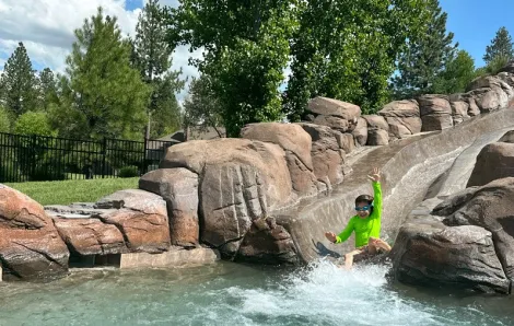  Young child slides down the waterslide at Sunriver Resort in Sunriver, Oregon