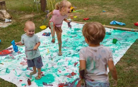 kids doing a messy art project outside