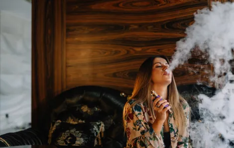 a woman smoking cannabis at home to relax