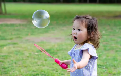 A toddler girl playing outside in the park enjoying free things to do in Seattle