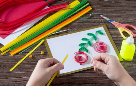 child crafting a pomegranate card for Rosh Hashanah 