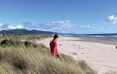 Person standing on the beach on a sunny day in Manzanita, Oregon