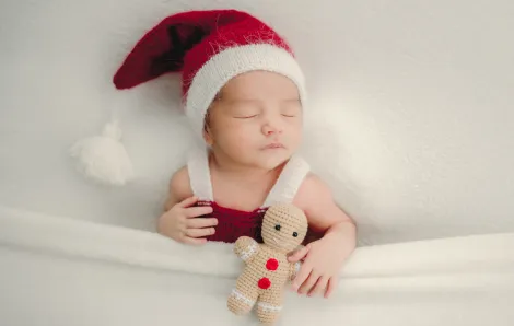 sleeping baby wearing a santa hat for a sweet and easy holiday photo