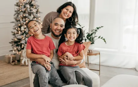 family smiling together for a holiday photo 