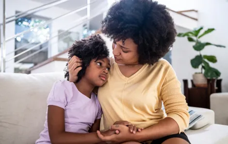 mom comforting daughter on the couch after a political election