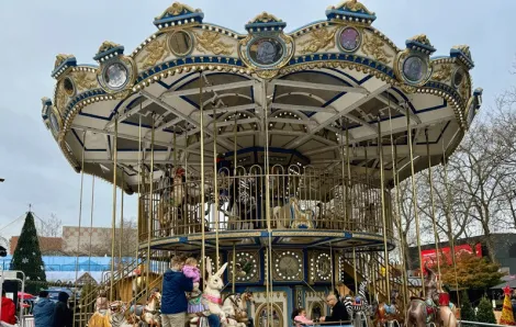 the double-decker carousel at Seattle Christmas Market, a fun family-friendly holiday attraction with Santa photo ops