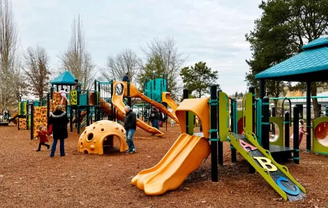 Family playing at Gene Coulon Memorial Park, a playground on the Eastside