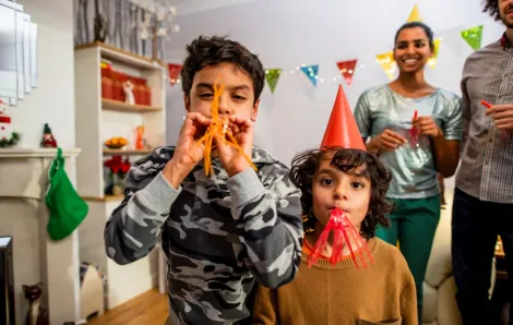 Family with two boys with blowers celebrating new years eve events in Seattle