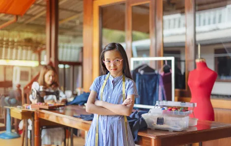 youth entrepreneur standing in front of her business