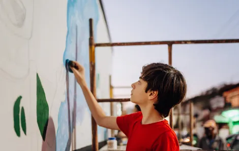 creative tween artist painting a mural