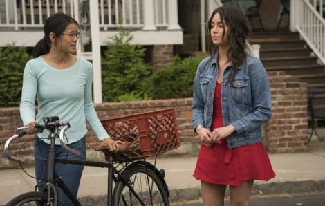 two girls walking on the sidewalk, a still image from the movie "The Half of It"