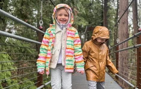 Kids walking across the suspension bridge at Bellevue Botanical Garden, a fun mid-winter break activity.