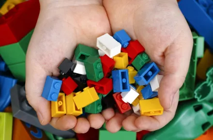 kid holding Lego bricks